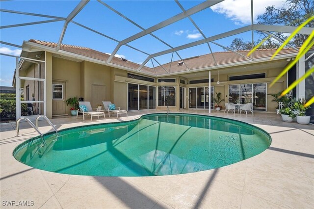 view of swimming pool with a lanai and a patio area