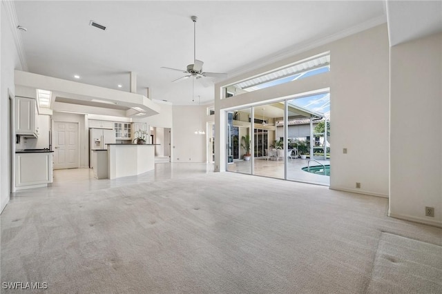 unfurnished living room with crown molding, light colored carpet, and ceiling fan