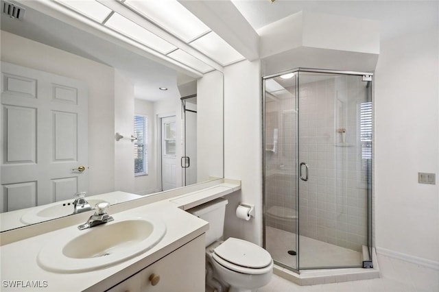 bathroom featuring walk in shower, vanity, and toilet