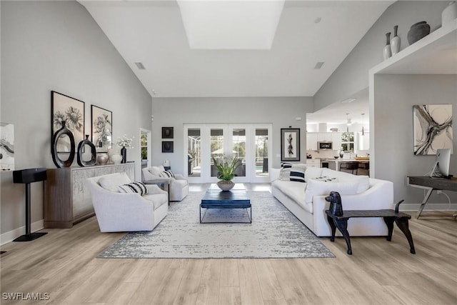 living room featuring high vaulted ceiling and light wood-type flooring