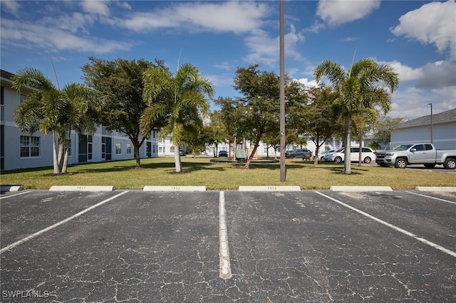 view of vehicle parking featuring a yard