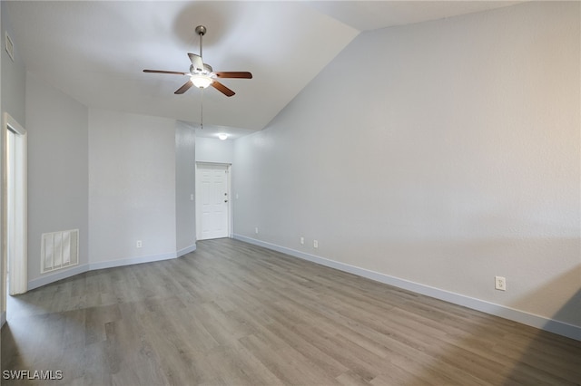 unfurnished room with lofted ceiling, ceiling fan, and light wood-type flooring