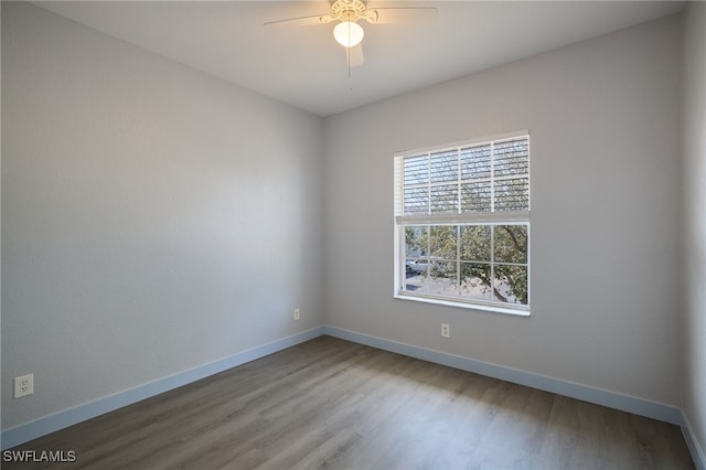 empty room with hardwood / wood-style flooring and ceiling fan