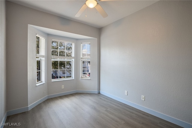 unfurnished room featuring hardwood / wood-style floors and ceiling fan