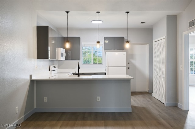 kitchen with gray cabinets, pendant lighting, sink, kitchen peninsula, and white appliances