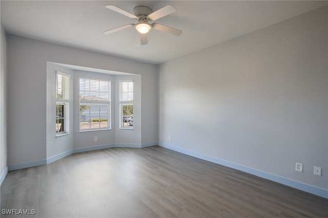 spare room with ceiling fan and wood-type flooring