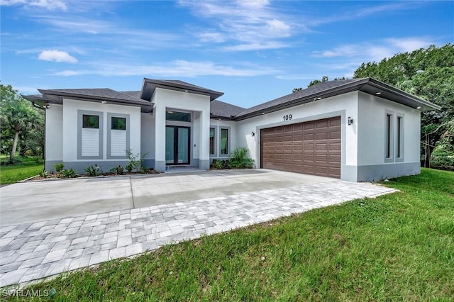 view of front of property featuring a garage and a front yard