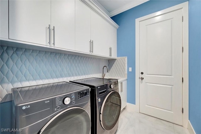 laundry area featuring sink, ornamental molding, cabinets, and independent washer and dryer