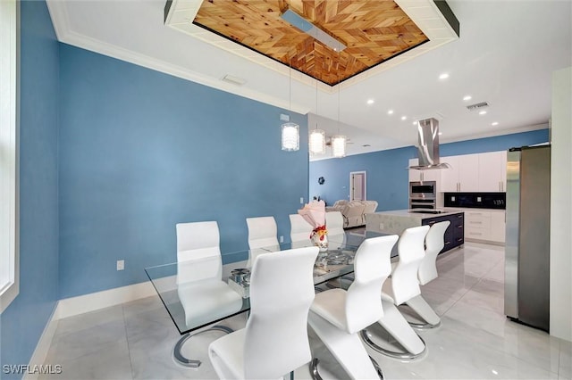 dining room featuring a raised ceiling and crown molding