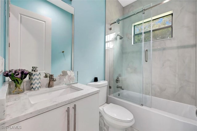 full bathroom featuring vanity, shower / bath combination with glass door, and toilet