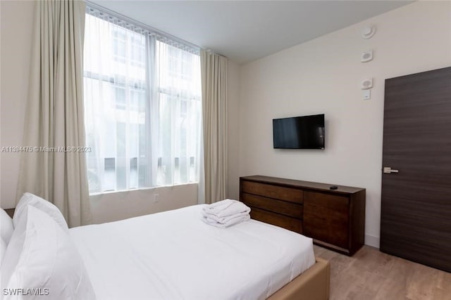 bedroom with light hardwood / wood-style flooring