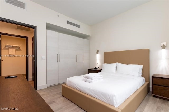 bedroom featuring light hardwood / wood-style flooring and a closet