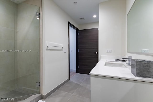 bathroom with tile patterned floors, vanity, and a shower with shower door