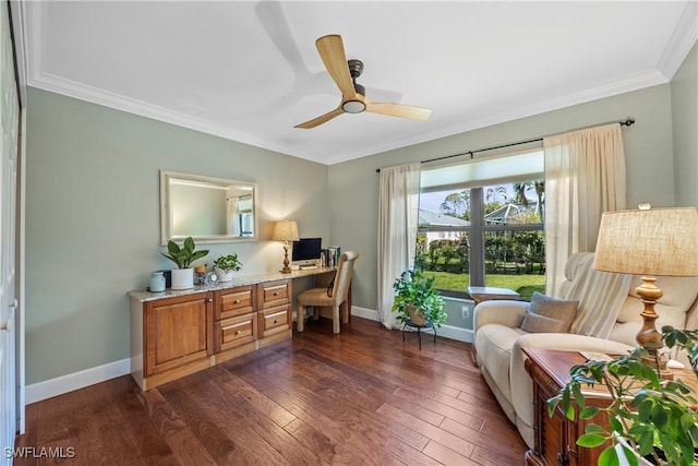 office space featuring dark hardwood / wood-style flooring, ornamental molding, and ceiling fan