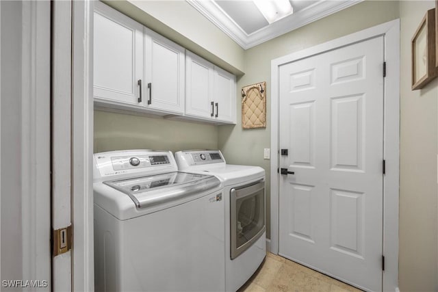 laundry room featuring crown molding, cabinets, and separate washer and dryer