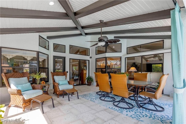 sunroom with lofted ceiling with beams and ceiling fan