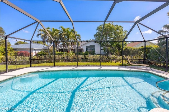 view of swimming pool with glass enclosure