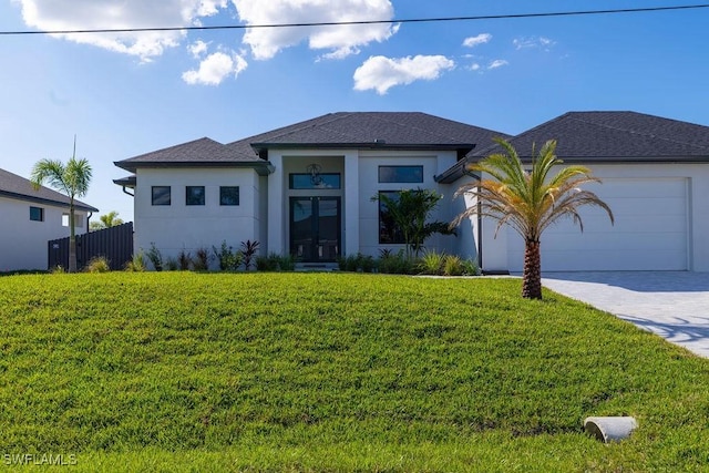 view of front of property with a garage and a front lawn