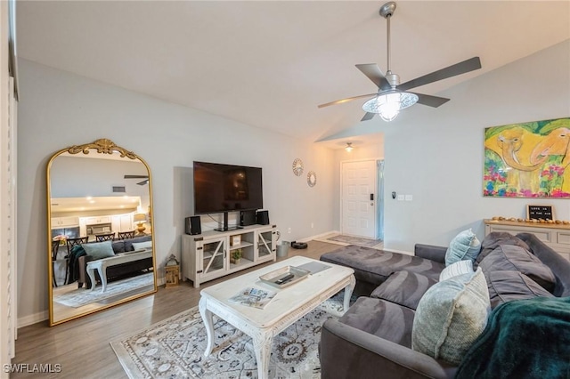 living room with vaulted ceiling, hardwood / wood-style floors, and ceiling fan