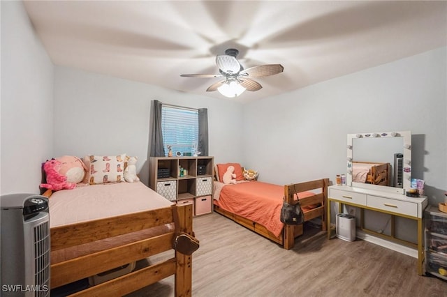 bedroom with hardwood / wood-style floors and ceiling fan