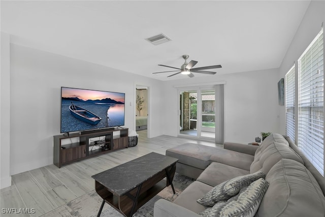 living room featuring light hardwood / wood-style floors and ceiling fan