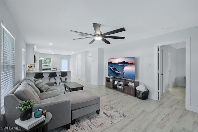 living room featuring ceiling fan and light wood-type flooring