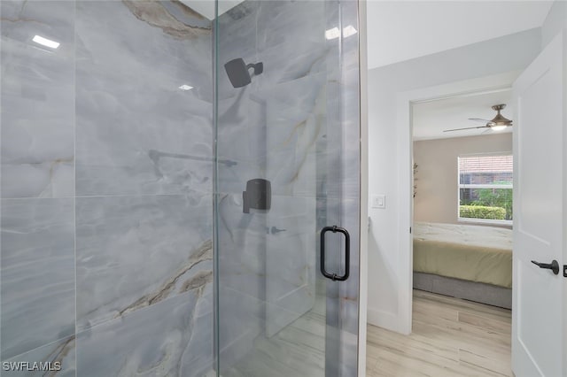 bathroom featuring an enclosed shower and hardwood / wood-style floors