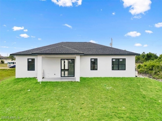 back of house with a patio area and a lawn