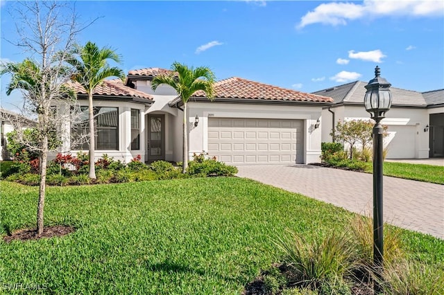 mediterranean / spanish home with a garage and a front lawn