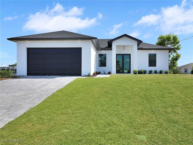 view of front of property featuring a garage and a front yard