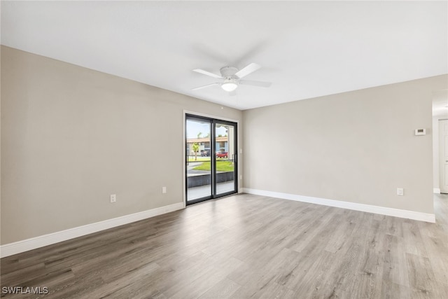 spare room featuring light hardwood / wood-style flooring and ceiling fan