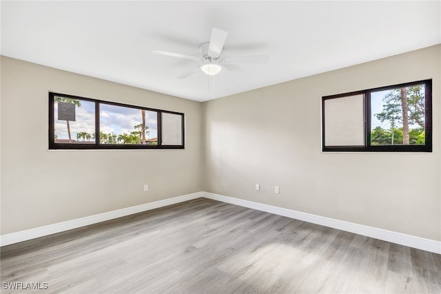 empty room with ceiling fan and light wood-type flooring