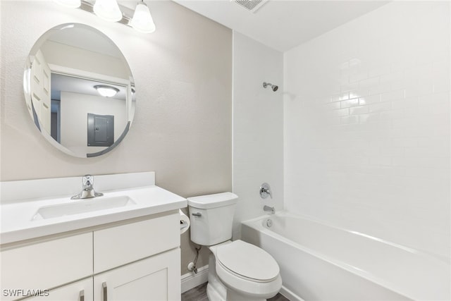 full bathroom featuring tiled shower / bath, electric panel, vanity, and toilet