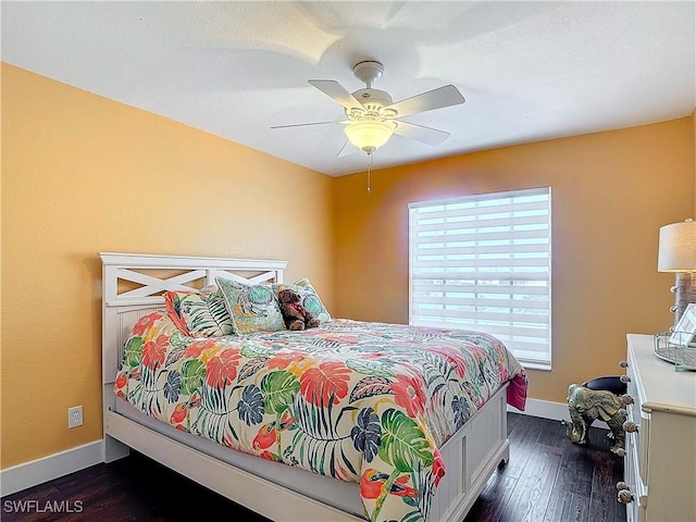 bedroom featuring dark hardwood / wood-style flooring and ceiling fan