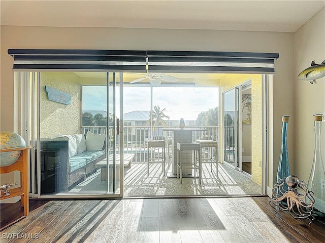 doorway to outside featuring hardwood / wood-style floors and ceiling fan