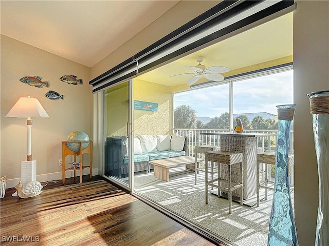 sunroom / solarium featuring lofted ceiling and ceiling fan