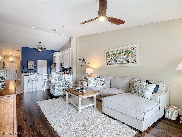 living room with ceiling fan, lofted ceiling, and dark hardwood / wood-style floors