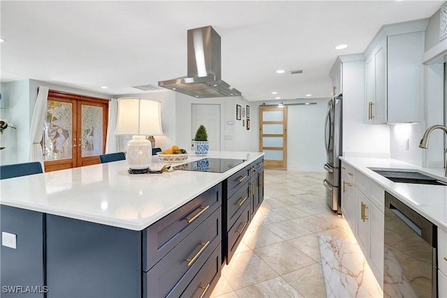 kitchen featuring extractor fan, sink, a center island, black appliances, and a barn door