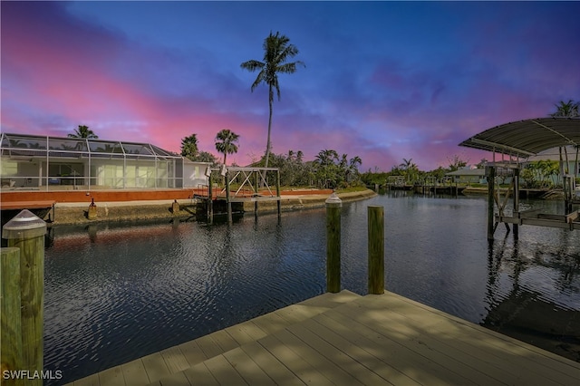 dock area featuring a water view and glass enclosure