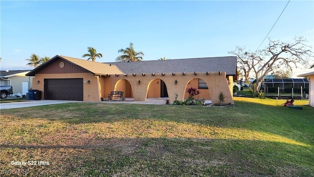 view of front of property featuring a garage and a front yard