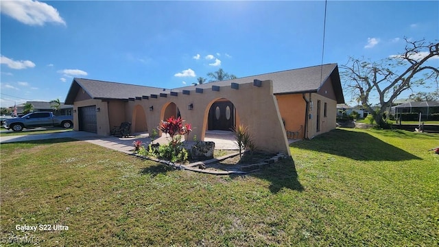 view of front of home with a garage and a front yard