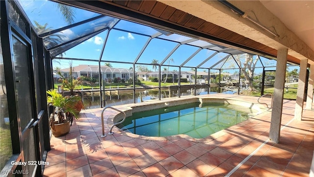 view of swimming pool featuring a water view, a lanai, a jacuzzi, and a patio