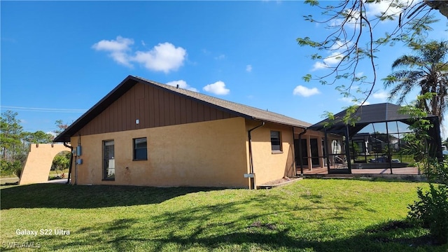 back of property featuring a yard and a lanai