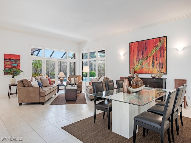 tiled dining area featuring crown molding and french doors