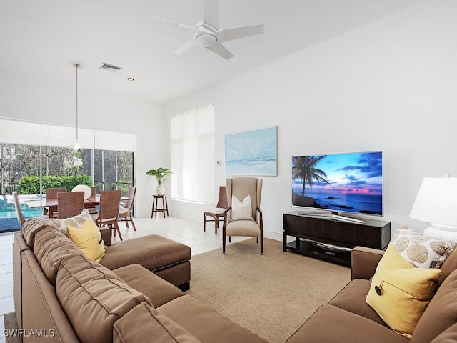 living room featuring light tile patterned flooring and ceiling fan