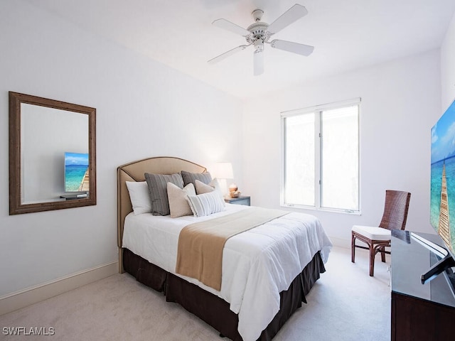 bedroom with ceiling fan and light colored carpet