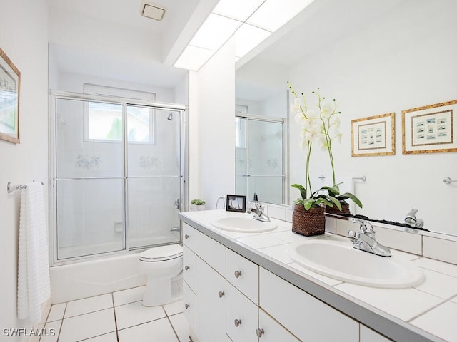 full bathroom featuring enclosed tub / shower combo, tile patterned floors, toilet, and vanity