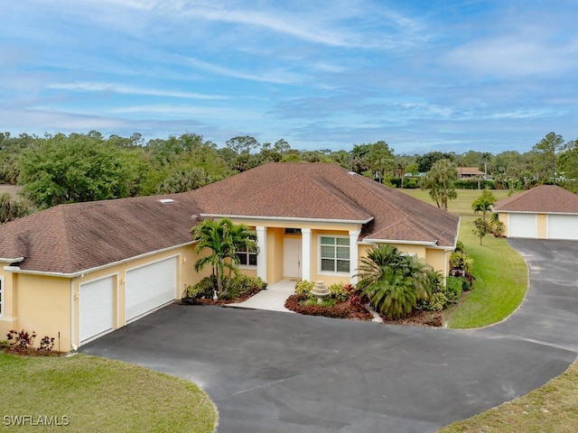 view of front of home featuring a garage and a front lawn