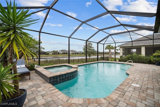 view of pool featuring a patio, a water view, an in ground hot tub, and glass enclosure