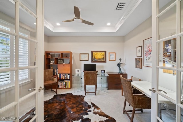 home office with french doors, crown molding, ceiling fan, and a raised ceiling